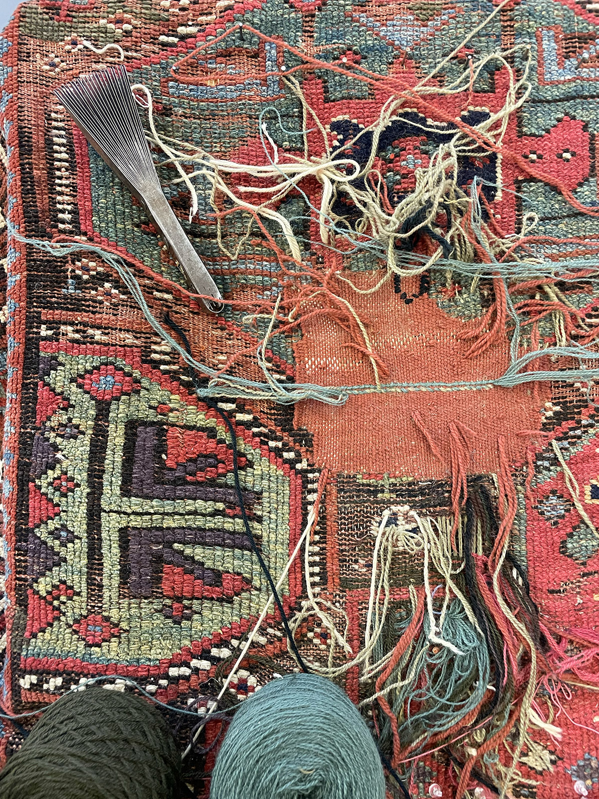 Extensive reweaving of a damaged area of a rug